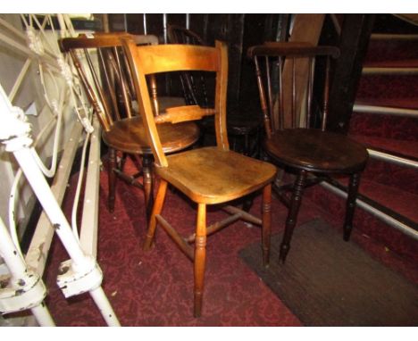 Three Swedish stained beechwood stick back kitchen chairs with circular seats raised on turned supports united by stretchers,