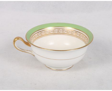 A Cauldon bone china green and gilt decorated part tea service for eight