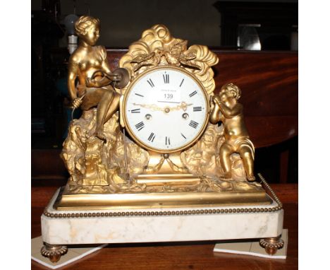 A white marble and gilt metal mantel clock surmounted a female nude and putto, white enamel dial with Roman numerals and eigh