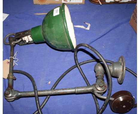An industrial wall light on hinged arm with green enamel shade
