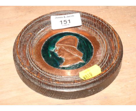 An Arts & Crafts copper and enamel portrait roundel, in oak frame, 5" dia
