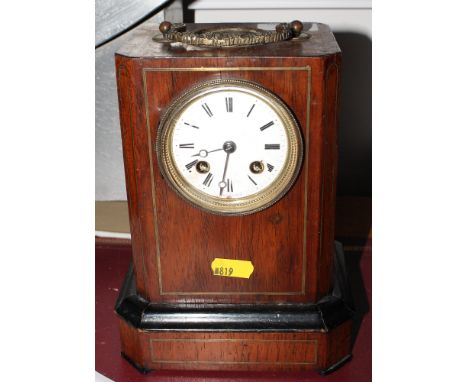 A French mantel clock with rosewood and inlaid case and white enamel dial