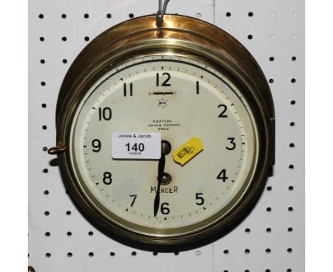 A Mercer brass bulkhead clock with painted dial, 7 1/2" dia