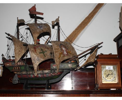 An early 20th Century painted wood model of a three masted warship and a Georgian design bracket clock by Rotherhams, 8" high