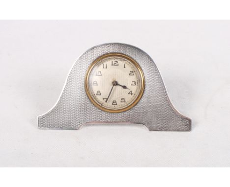 An Art Deco silver strut clock with engine turned decoration and silvered dial