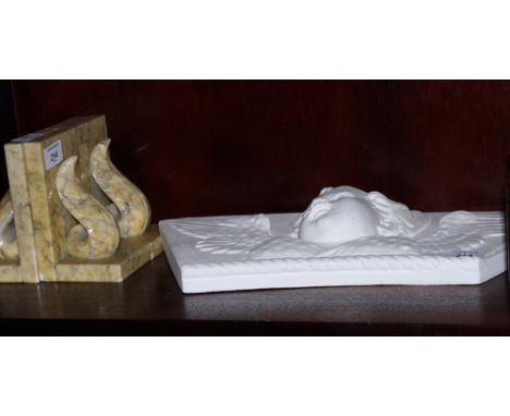 Two pairs of marbled alabaster bookends carved scrolls and a curved plaster panel of a winged cherub's head stamped "D BRUCCI