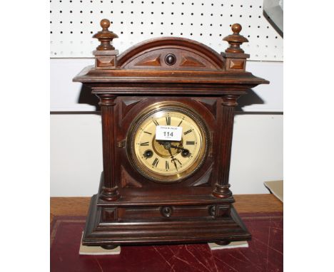 A late 19th Century mantel clock in polished wood case, brass and silvered dial, 19" high, and a similar smaller mantel clock