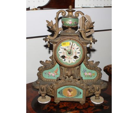 A late 19th Century mantel clock in gilt metal case inset green floral decorated porcelain panels, urn surmount, 12" high