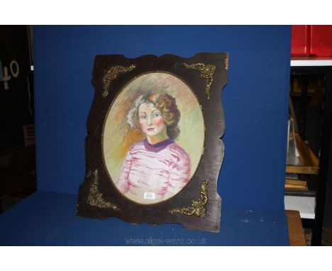 A large oval unsigned portrait in Watercolour of a young girl, in a wooden frame with gilt coloured beading and leaf decorati