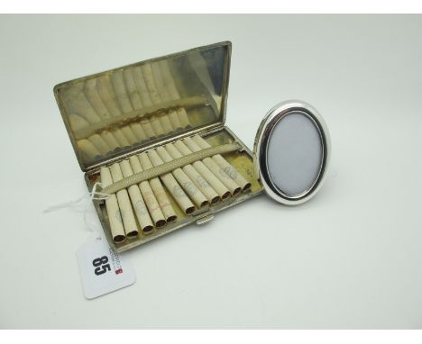A Slim Engine Turned Cigarette Case, initialled, stamped "Silver", 12.9cm; together with a small oval photograph frame, stamp