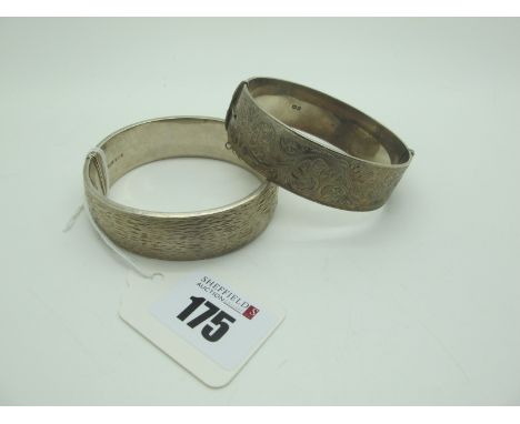 A Wide Hallmarked Silver Hinged Bangle, allover textured finish; Together with Another Example, leaf scroll engraved to the f