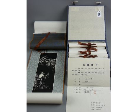 Four Chinese block print and silk scroll panels in a fabric covered case with bone fasteners and associated paperwork, 127 x 
