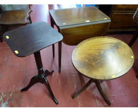 A reproduction mahogany twin flap side table, an oval topped walnut side table and a mahogany wine table with twist column on