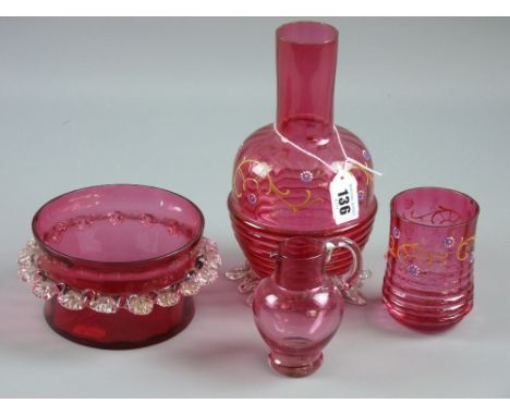 Four pieces of cranberry glass to include an enamel painted rib patterned carafe and beaker, a small handled jug and a 13 cms