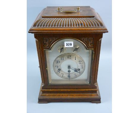 An early 20th Century oak cased bracket clock, the pendulum driven movement striking on gongs with chimes silent and fast/slo