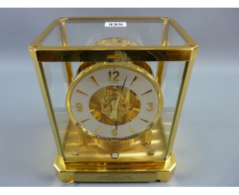 A Jaeger Le Coultre Atmos clock in a brass and glass case, 20th Century Swiss made with presentation plaque indicating twenty