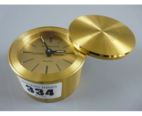 A 20th Century Tiffany & Co cylindrical brass cased Quartz travel alarm clock, marked to the dial 'Tiffany & Co', 6 cms diame