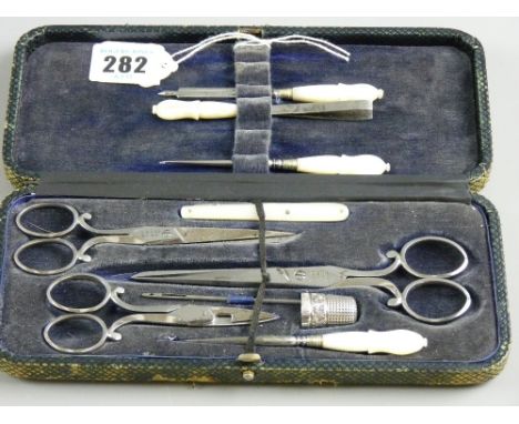 A cased vintage needlework set to include a Charles Horner Chester hallmark silver thimble, date mark 1922, three sets of Woo