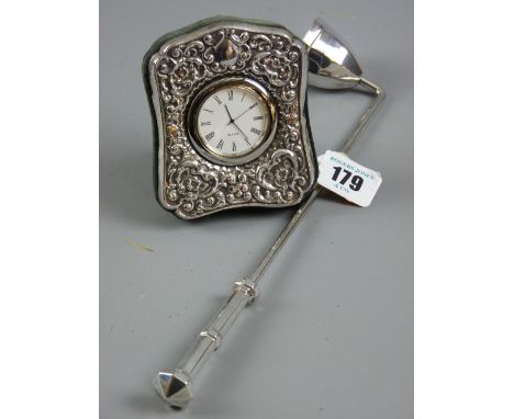 A silver fronted velvet framed Quartz bedroom clock, hallmarked Birmingham 1997 together with a silver plated candlesnuffer