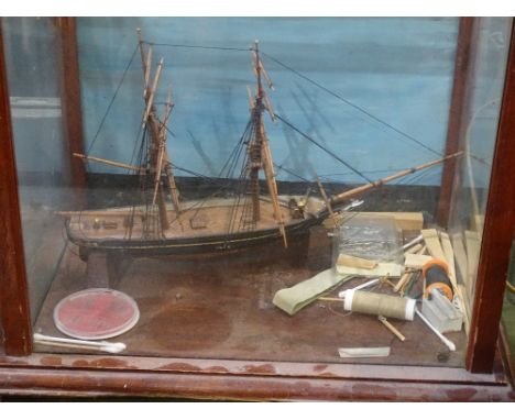 A display case containing a model ship 