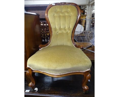 A Victorian carved walnut framed and button-back upholstered nursing chair 
