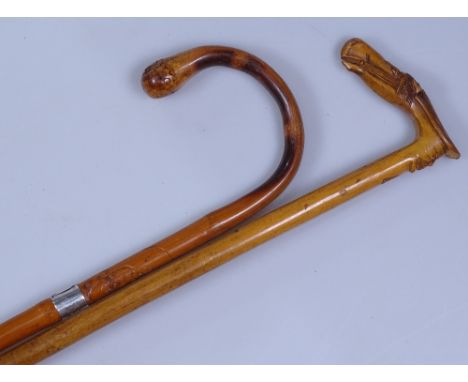 A horse's head walking stick, and another 