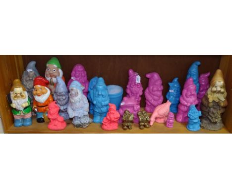 A shelf full of painted garden gnomes 