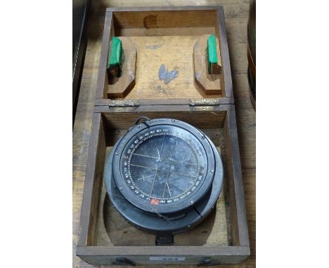 A type PS cased gimbaled compass, 5" across, and USSR 12x40 binoculars, cased 
