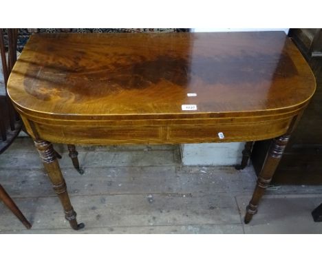 A 19th century cross-banded mahogany fold over card table, with boxwood stringing and banding, raised on turned legs, W91cm 