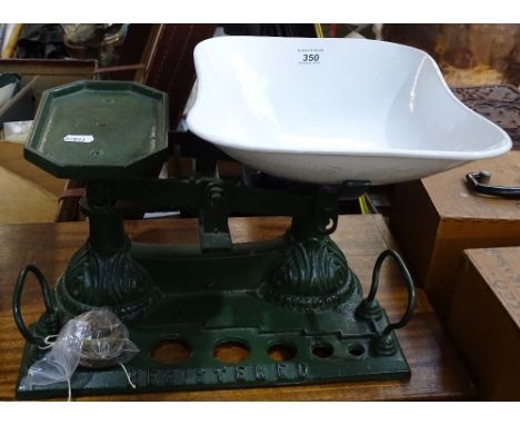 A cast-iron kitchen scale with enamel pan, and brass weights 