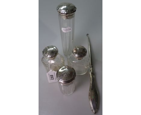 A set of 4 silver-mounted glass toilet bottles, and a silver-handled button hook 
