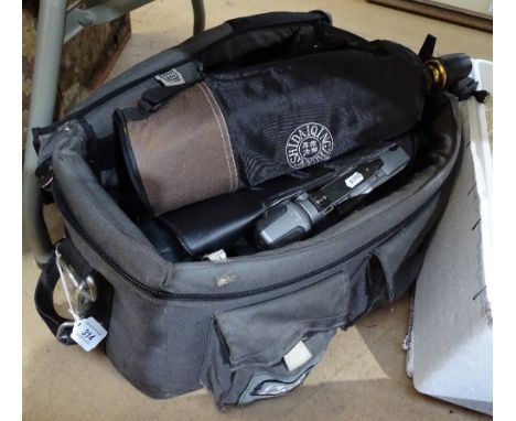 A Canon camera, a Cosina camera, lenses and tripods 