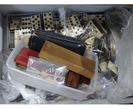 A box containing various sets of Vintage dominos 