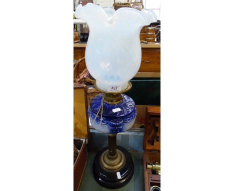 An Edwardian oil lamp with china font and glass shade, converted to electric, height 24" 