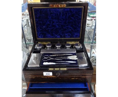 A Victorian Coromandel toilet set, complete with engine turned silver-topped toilet bottles, and a mother-of-pearl handled ma