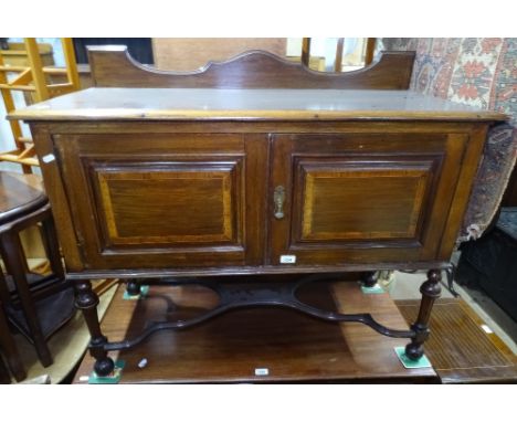 An Edwardian mahogany and satinwood-banded washstand, with panel doors, and shaped stretchers, W100cm 