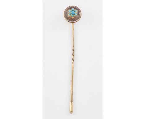 A ROCK CRYSTAL AND TURQUOISE STICKPIN, a rock crystal cabochon star set with a cluster of turquoise. 1.3cm diameter&nbsp;COND