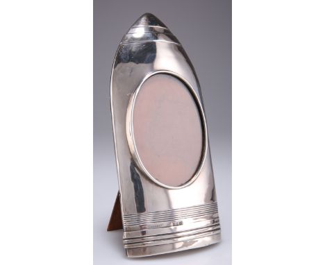 A GEORGE V SILVER PHOTOGRAPH FRAME,&nbsp;by&nbsp;W H Haseler Ltd,&nbsp;Birmingham 1916, in the shape of an artillery shell ca