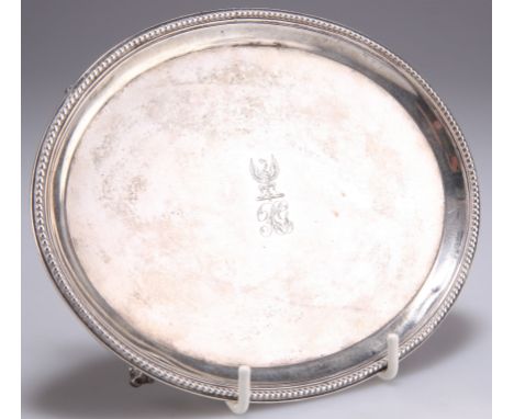 A GEORGE III SILVER TEAPOT STAND,&nbsp;by&nbsp;Robert Jones I, London 1780, oval with beaded edge, raised on ball and claw fe