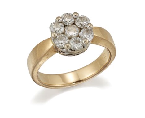 A DIAMOND CLUSTER RING, seven round brilliant-cut diamonds in claw settings, to a broad shank. Estimated total diamond weight