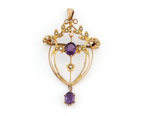 AN AMETHYST AND SEED PEARL BROOCH / PENDANT, an oval-cut amethyst within a seed pearl-set foliate frame, with an amethyst dro