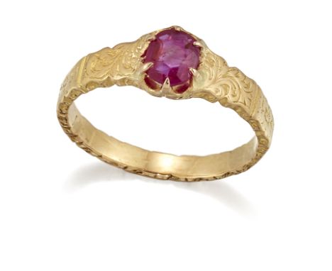 A RUBY RING, an oval-cut ruby in a claw setting, to a fancy foliate engraved panelled shank. Ring size K1/2, 2.9 gramsCONDITI