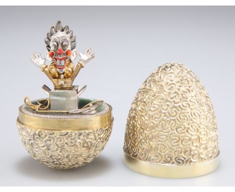 AN ELIZABETH II SILVER-GILT SURPRISE EGG,&nbsp;by Stuart Devlin, London 1989,&nbsp;no. 215, the textured body opening to reve