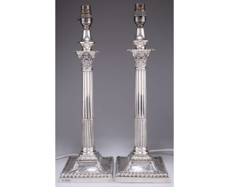 A PAIR OF EDWARDIAN SILVER CORINTHIAN COLUMN LAMP BASES,&nbsp;by&nbsp;Hawksworth, Eyre &amp; Co Ltd, Sheffield 1904 and 1908,