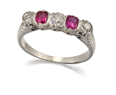 A RUBY AND DIAMOND RING, three graduated old-cut diamonds spaced by two cushion-cut rubies, above a carved gallery. Estimated