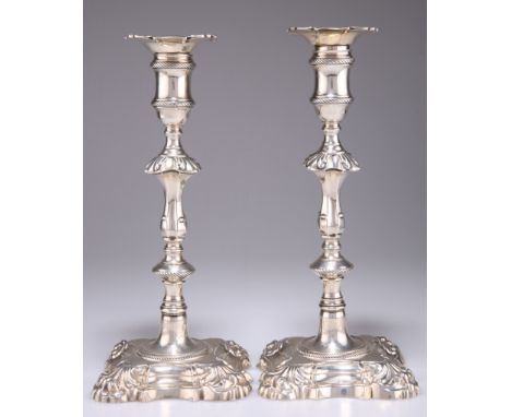 A PAIR OF GEORGE II CAST SILVER CANDLESTICKS, by John Cafe, London 1755, each with knopped stem and shaped square base, engra