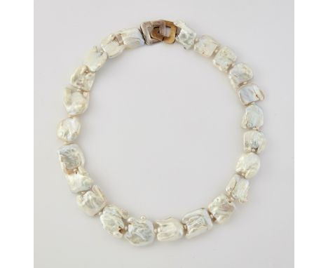 A CULTURED PEARL NECKLACE, large baroque pearls spaced by button pearls, to a fancy hook clasp. 48cm long&nbsp;