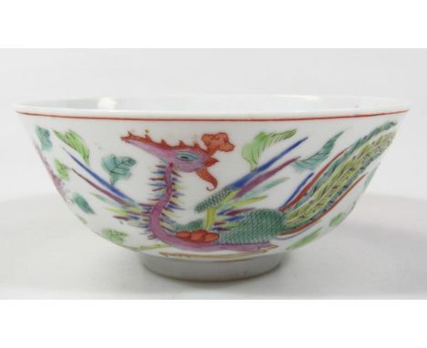 A Chinese porcelain bowl, the circular body polychrome decorated with flowers and exotic birds, predominantly in green, yello