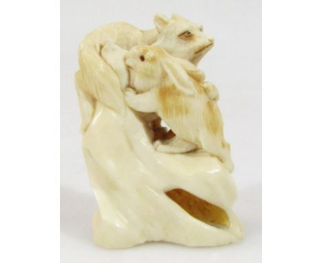A 19thC Japanese Meiji period ivory carving of a rabbit and fox, 5cm high, unmarked.