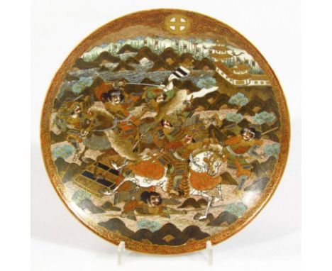 A 19thC Japanese satsuma saucer dish, of circular outline, profusely decorated with figures of samurai, other warriors, horse